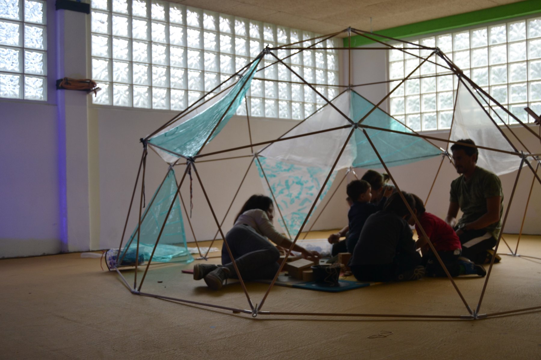 Una familia ocupa el interior de una estructura geodésica translúcida de Irisada.